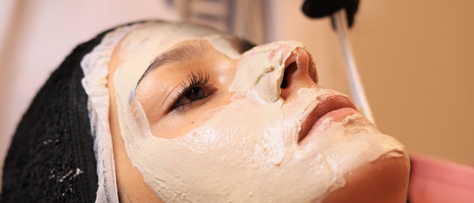 A brightening treatment being applied to a client's face at Plum & Sugar