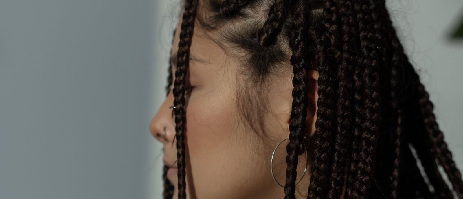 A client with freshly finished box braids at Plum & Sugar