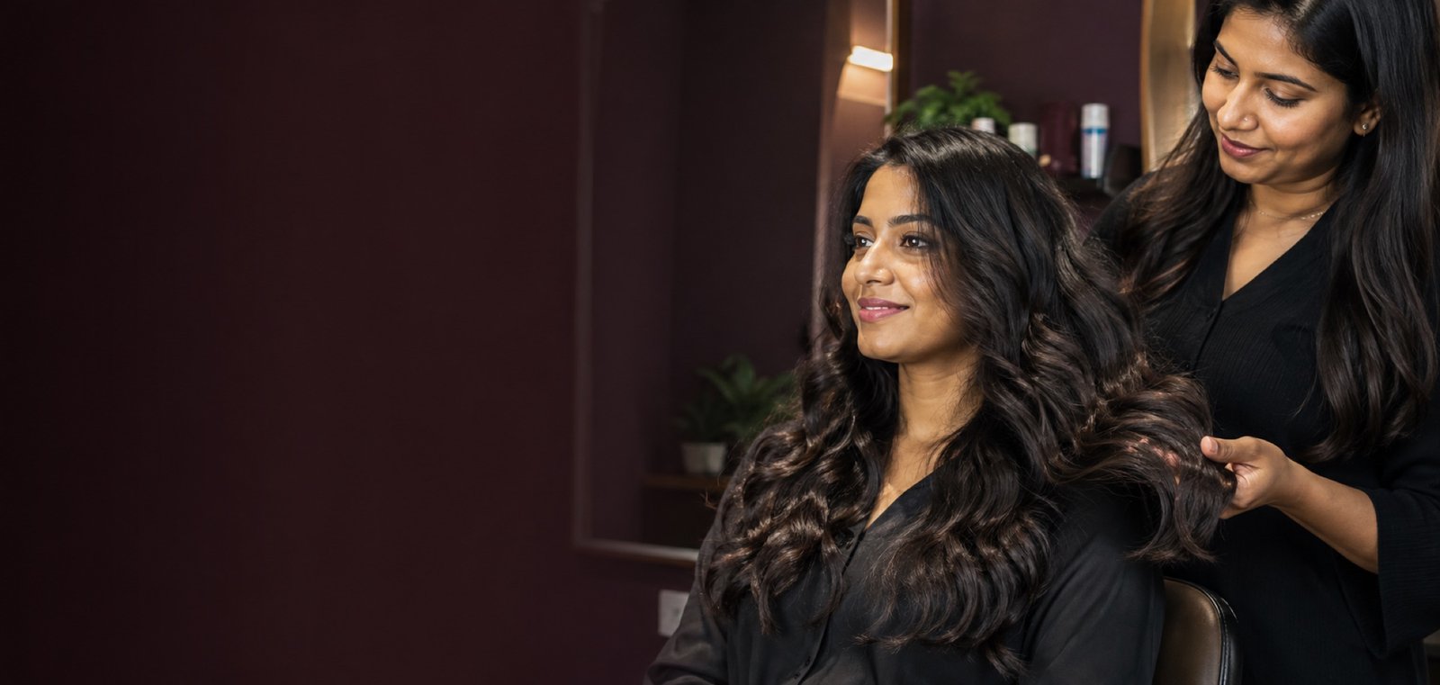 Indian client with stronger, glossy naturally wavy hair after a Protein Re-filler treatment