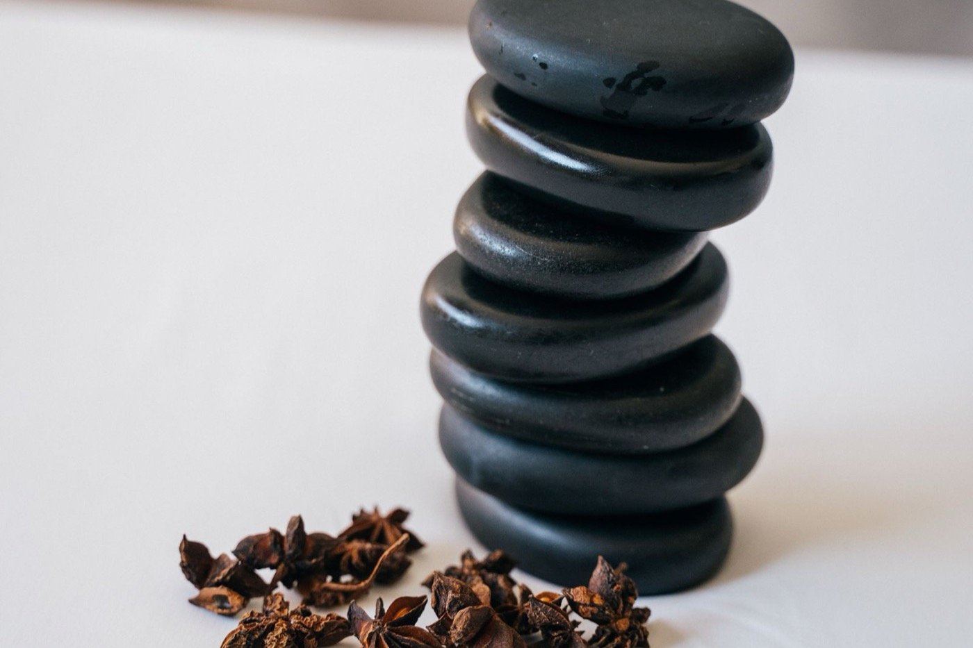 Hot stones and spa elements laid out for a signature combo at Plum & Sugar