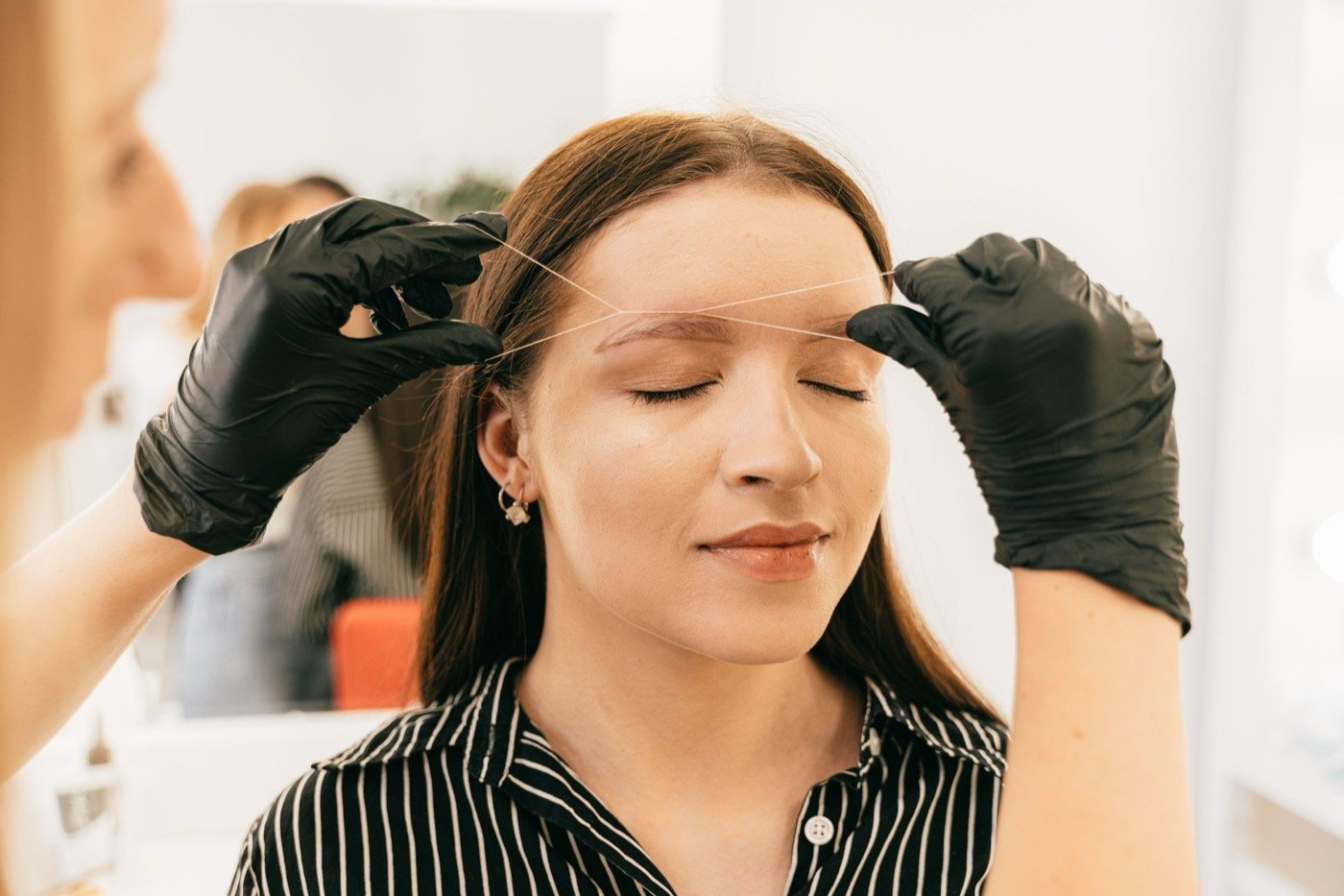 A client with freshly shaped brows at Plum & Sugar